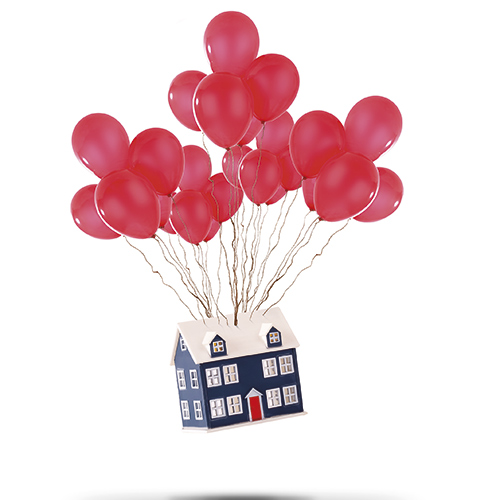 Model house suspended in the air by red balloons